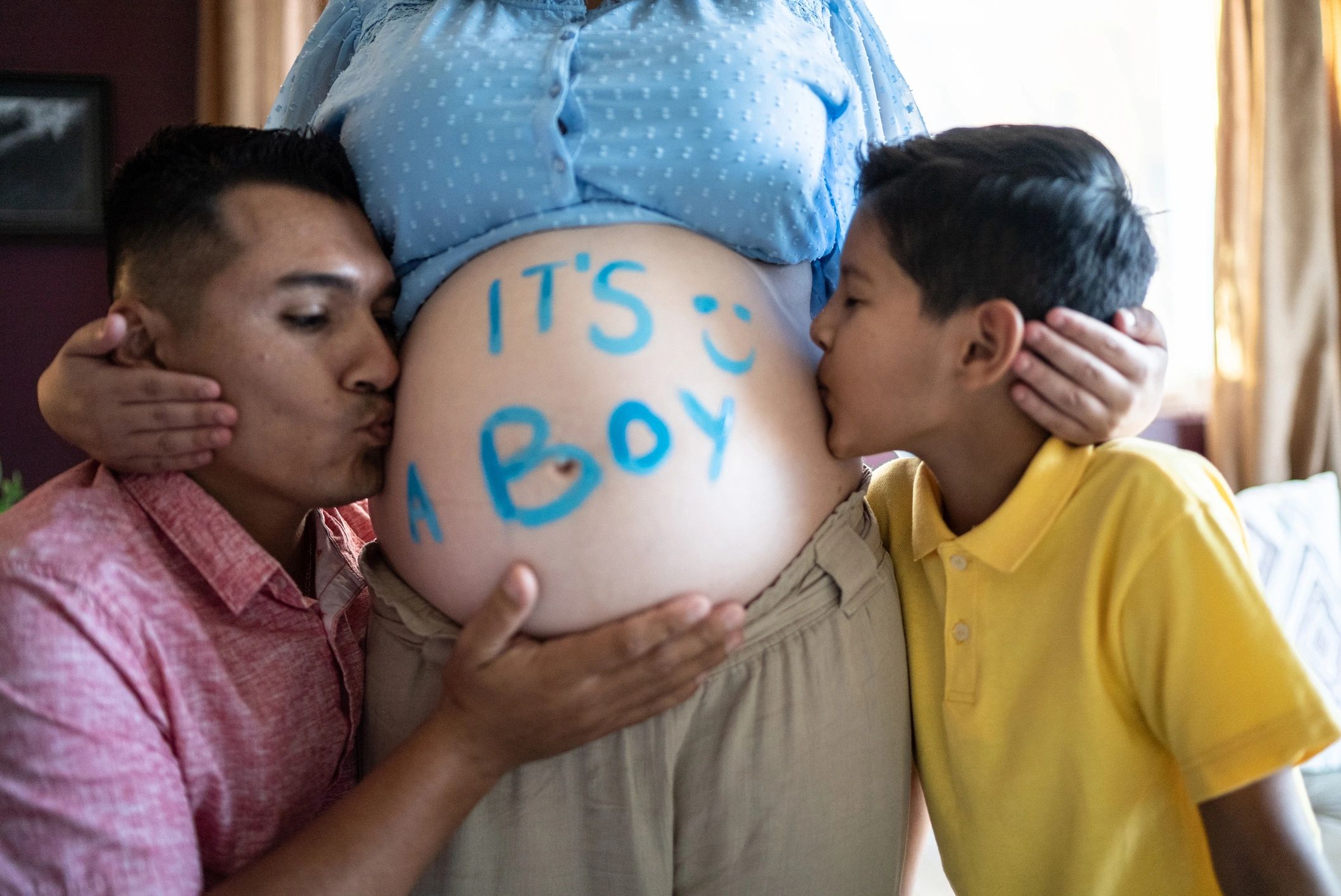 Family celebrating a gender reveal at home
