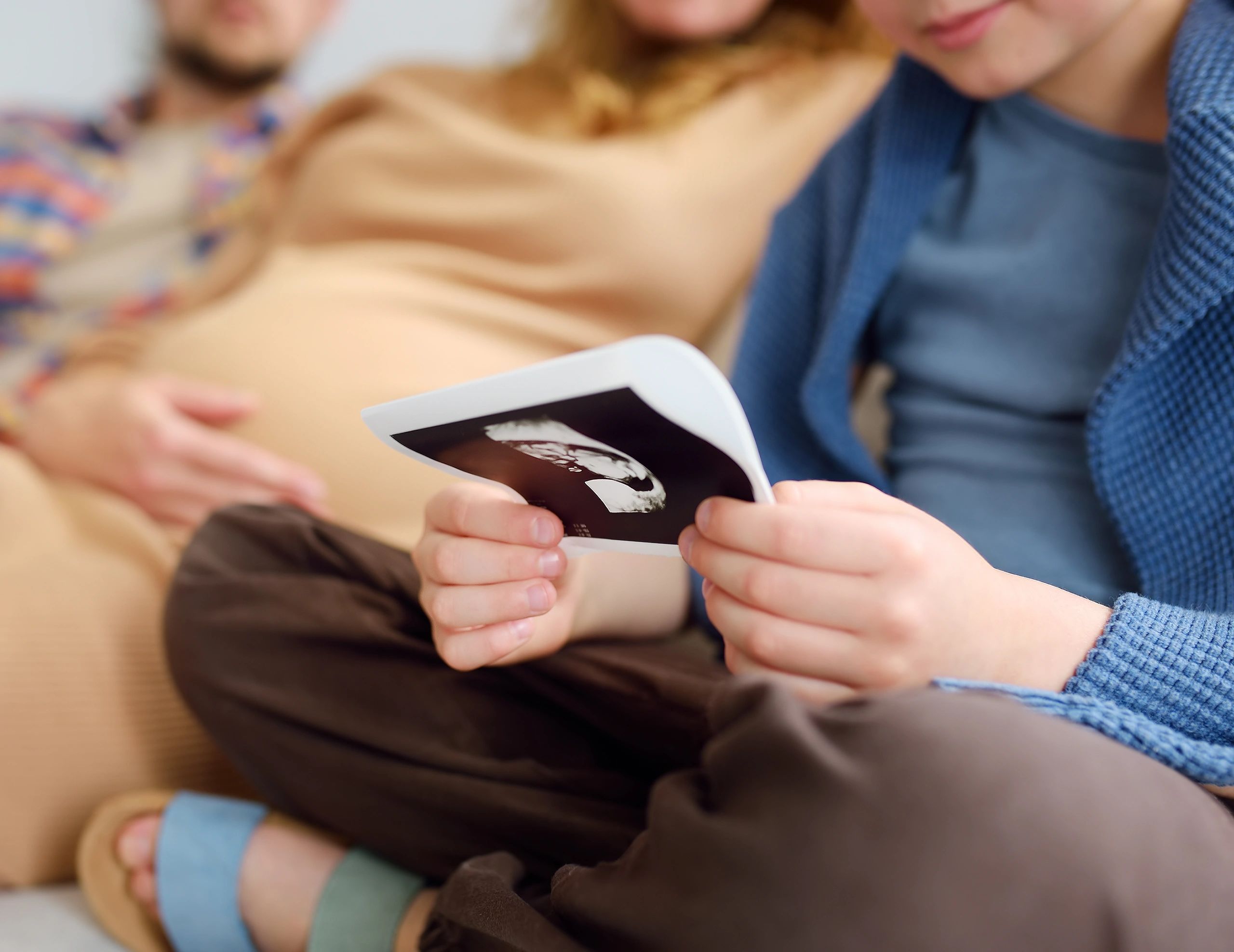 Family looking at ultrasound pictures together